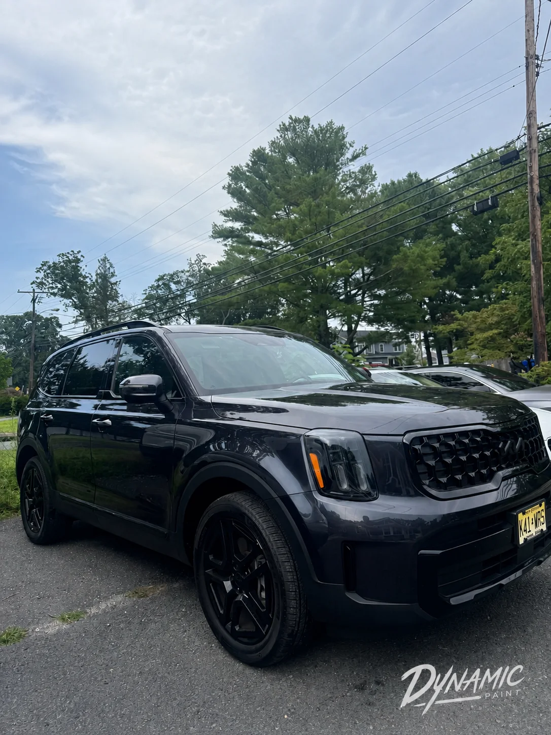 Dark Kia Telluride with black wheels